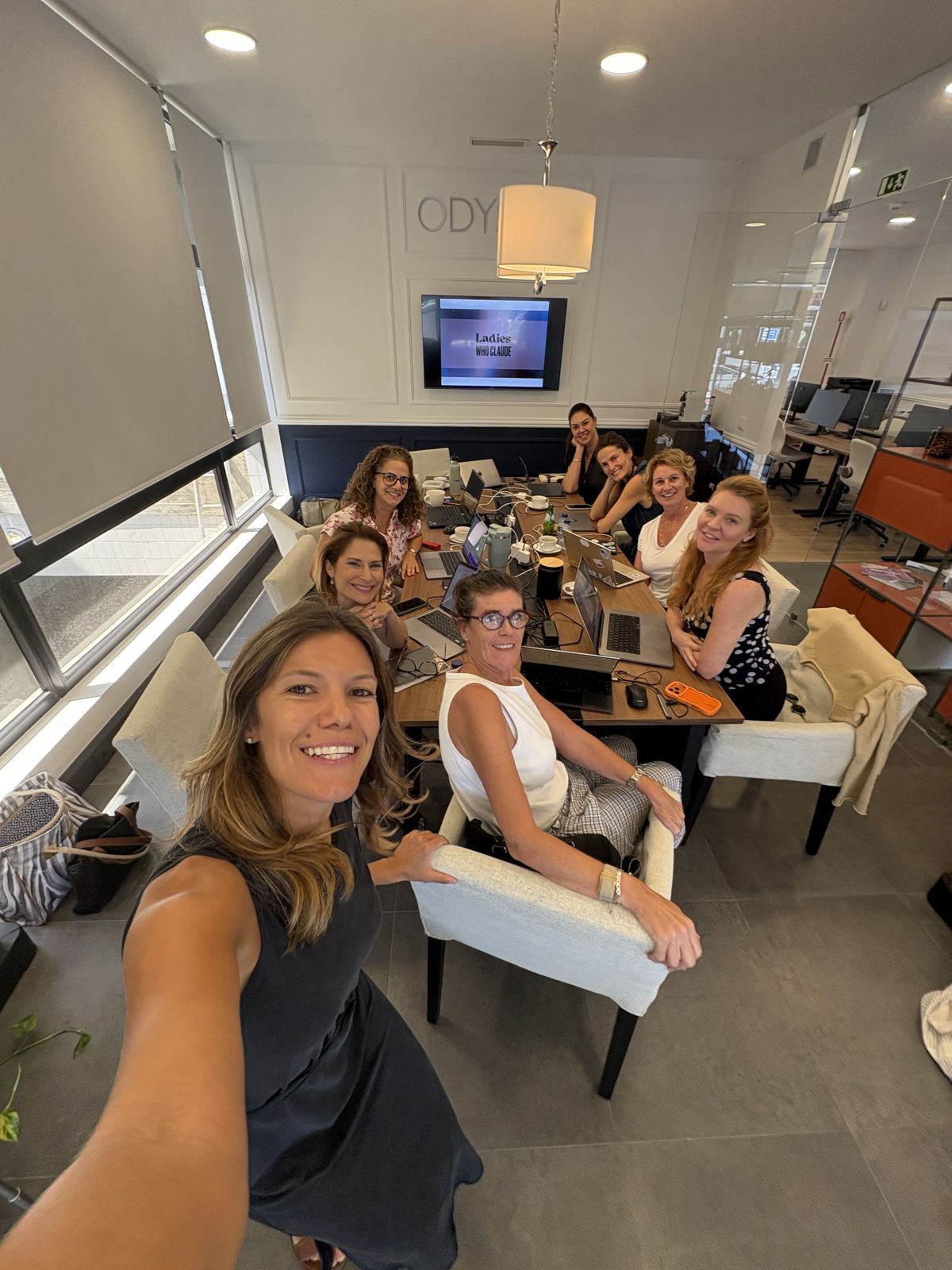 Nina with a workshop group around a boardroom table